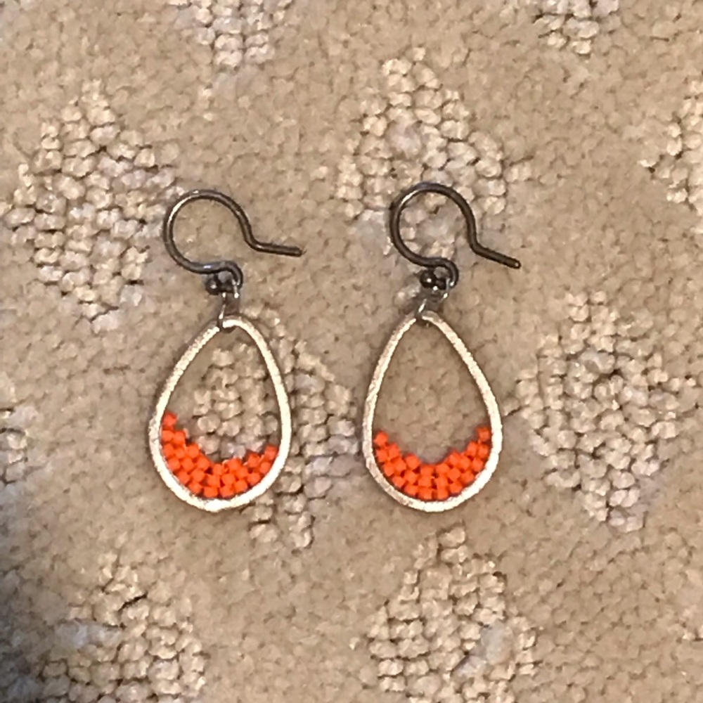 silver oval hoop earrings with orange accent